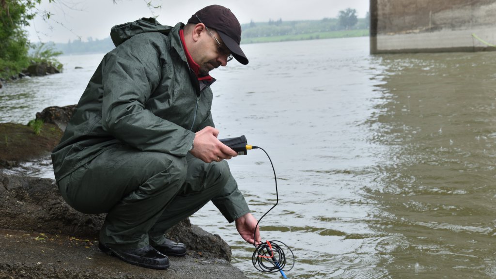 A man sampling in the river